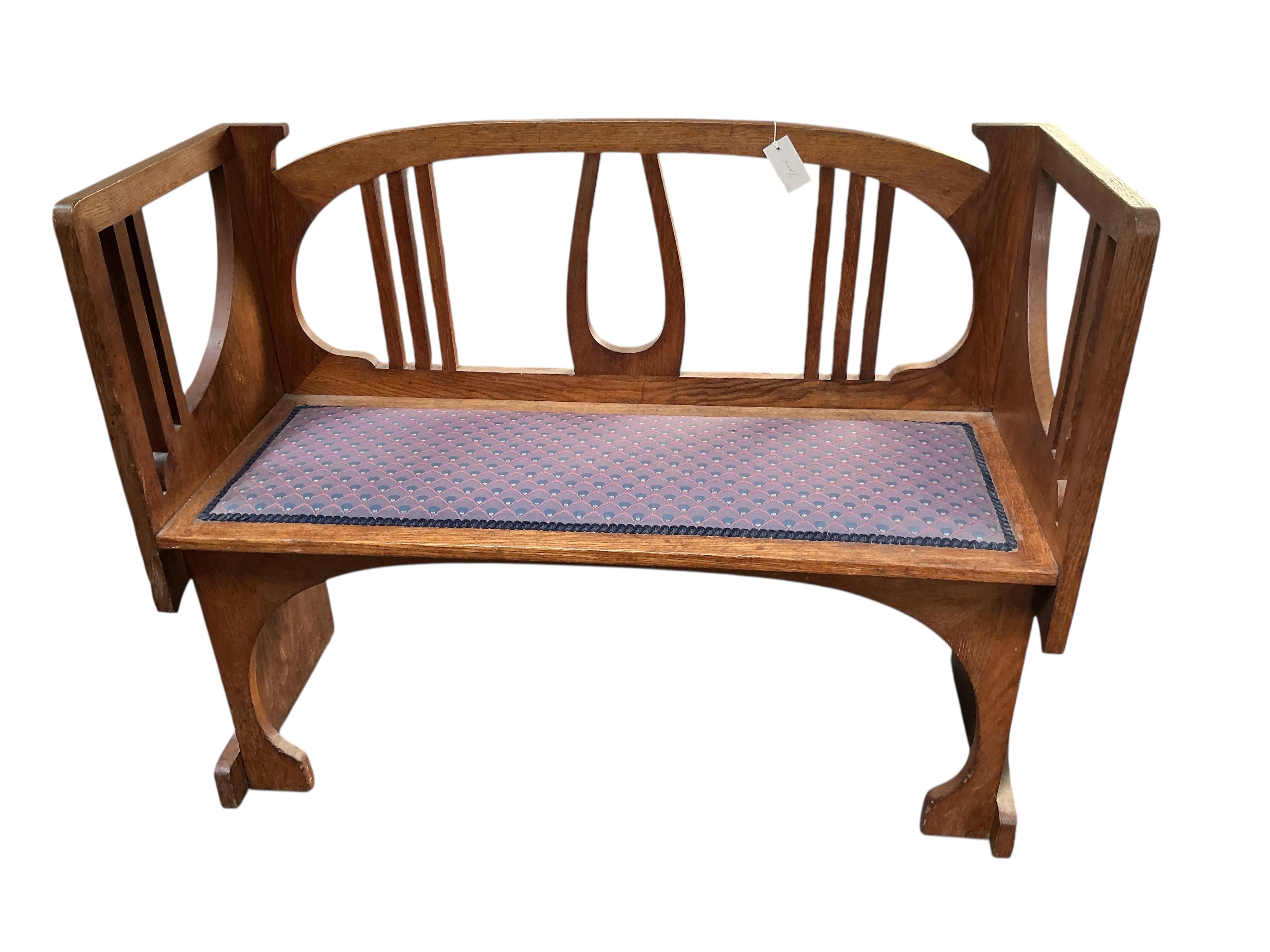 In the manner of Josef Hoffmann, an Art Nouveau oak chair-back settee and similar stool, settee width 110cm, depth 43cm, height 87cm.